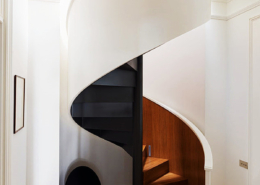White spiral staircase with steel plate