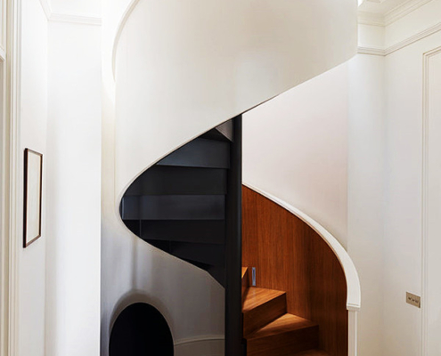 White spiral staircase with steel plate