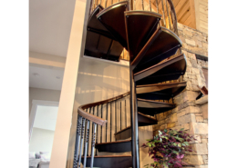 Outdoor metal spiral staircase with iron railing wooden treads